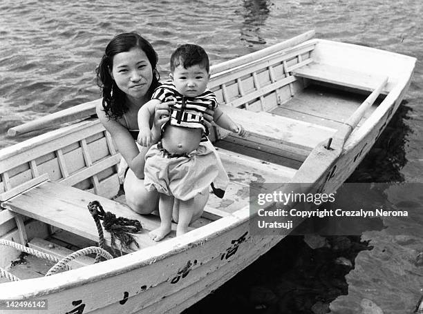 little boy and woman in boat - showa period fotografías e imágenes de stock
