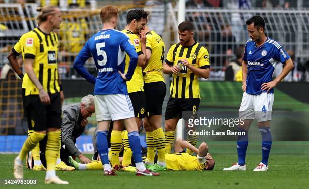 Marco Reus of Dortmund lies injured on the pitch during the Bundesliga match between Borussia Dortmund and FC Schalke 04 at Signal Iduna Park on...