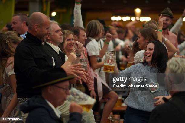 Revelers enjoy to stay in the Ochsenbraterei Spaten tent on day two of the 2022 Oktoberfest beer fest on September 18, 2022 in Munich, Germany. This...