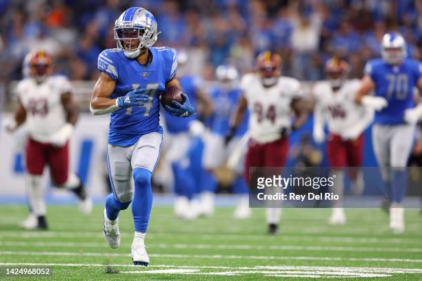 Amon-Ra St. Brown of the Detroit Lions runs with the ball after making a catch against the Washington Commanders during the first quarter at Ford...