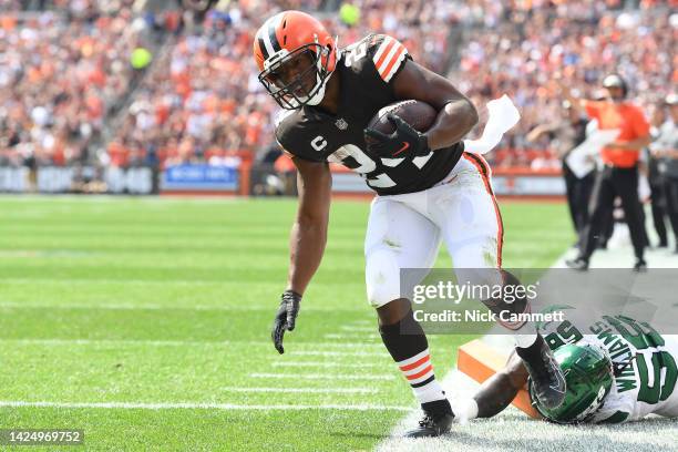 Nick Chubb of the Cleveland Browns runs with the ball after getting pushed out of bounds by Quincy Williams of the New York Jets during the first...