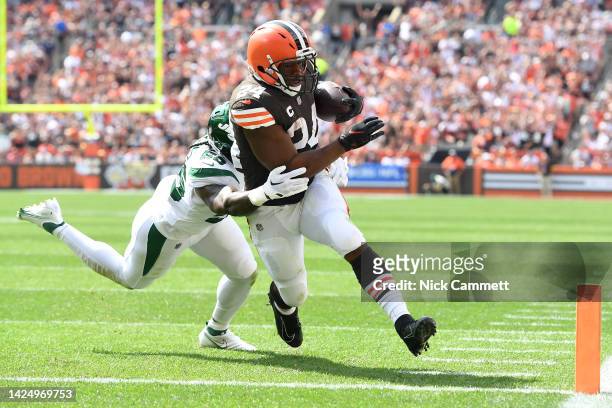 Nick Chubb of the Cleveland Browns runs with the ball as Quincy Williams of the New York Jets chases during the first quarter at FirstEnergy Stadium...