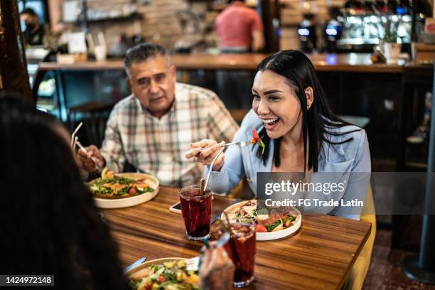 coworkers having lunch together in a restaurant - mexican food plate stock pictures, royalty-free photos & images