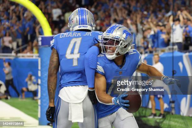 Amon-Ra St. Brown of the Detroit Lions celebrates with DJ Chark after a making a catch for a touchdown against the Washington Commanders during the...