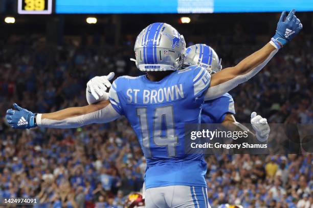 Amon-Ra St. Brown of the Detroit Lions is congratulated after a making a catch for a touchdown against the Washington Commanders during the first...