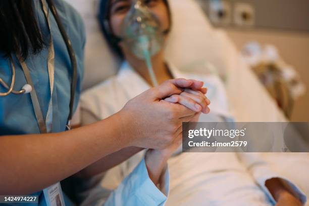 closed-up of an asian chinese woman wearing oxygen mask at a hospital ward - chemotherapy stock pictures, royalty-free photos & images