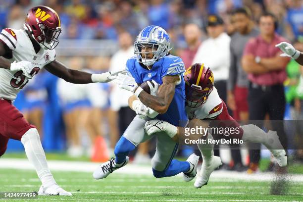 Jameson Williams of the Detroit Lions is tackled by Cole Holcomb of the Washington Commanders during the first quarter at Ford Field on September 18,...