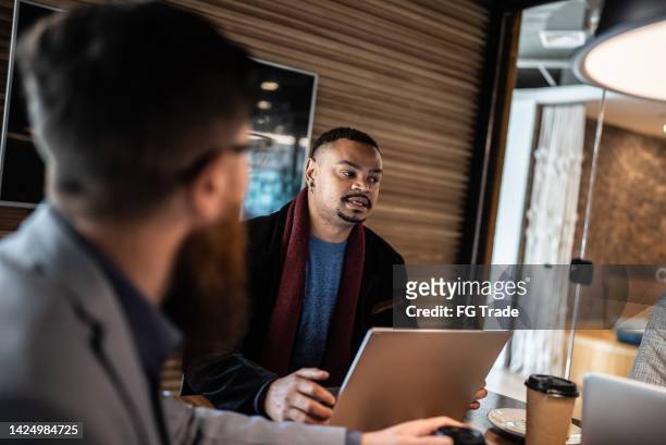 coworkers in a meeting at the office - tech founder stock pictures, royalty-free photos & images