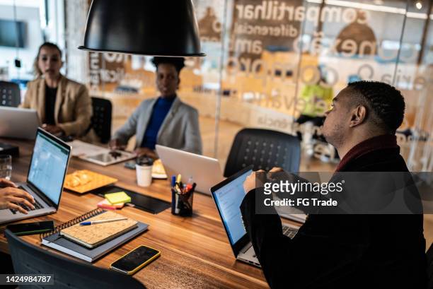 coworkers in a meeting at the office - tech founder stock pictures, royalty-free photos & images