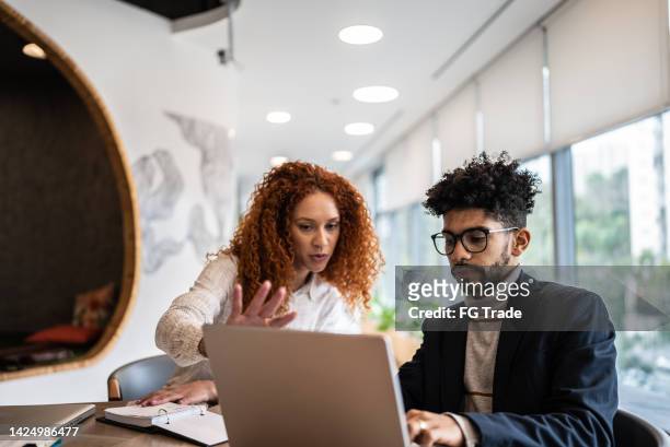 coworkers in a meeting at the office - candid curly hair stock pictures, royalty-free photos & images