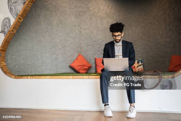 mid adult man using the laptop at the office - small business copy space stock pictures, royalty-free photos & images