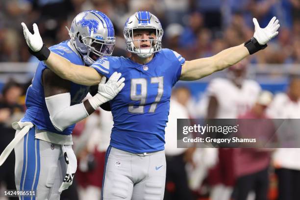 Aidan Hutchinson of the Detroit Lions is congratulated by Michael Brockers after making his first career sack during the first quarter of the game...