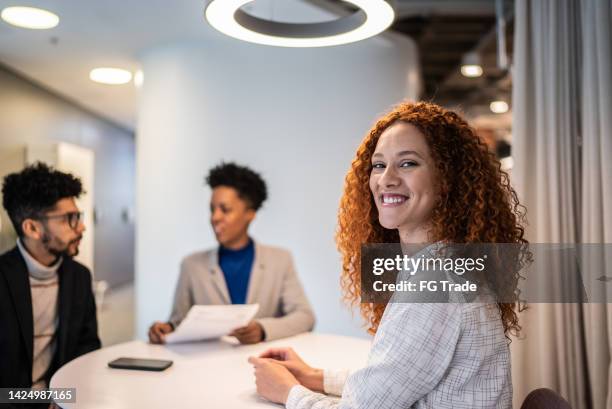 portrait of businesswoman in a meeting or a job interview at the office - recruiter stockfoto's en -beelden