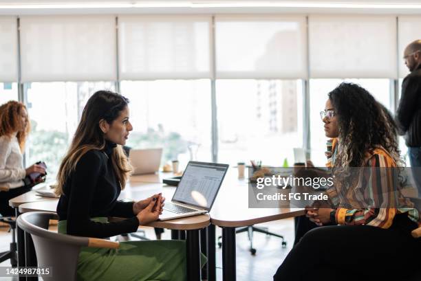 coworkers talking in the office - founders stockfoto's en -beelden