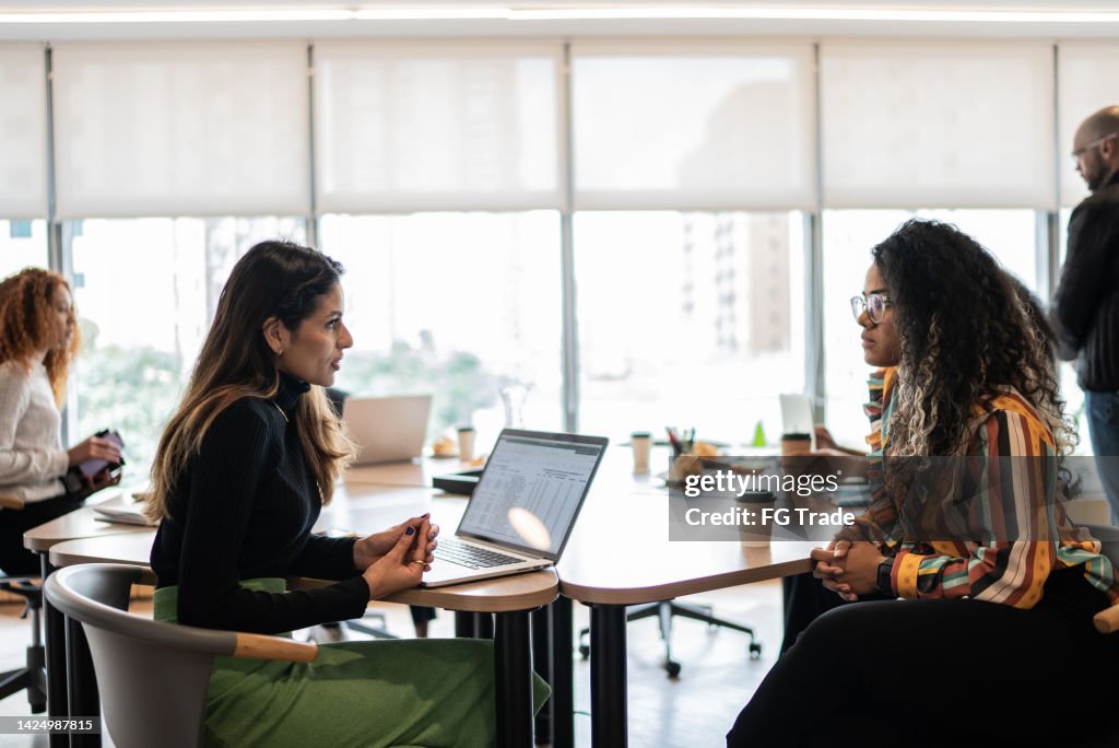 Coworkers talking in the office