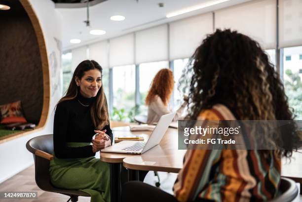 coworkers talking in the office - founder of kids company camila batmanghelidjh leaves lbc studios stockfoto's en -beelden