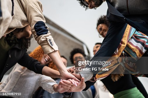 Coworkers with stacked hands at the office Coworkers with stacked hands at the office