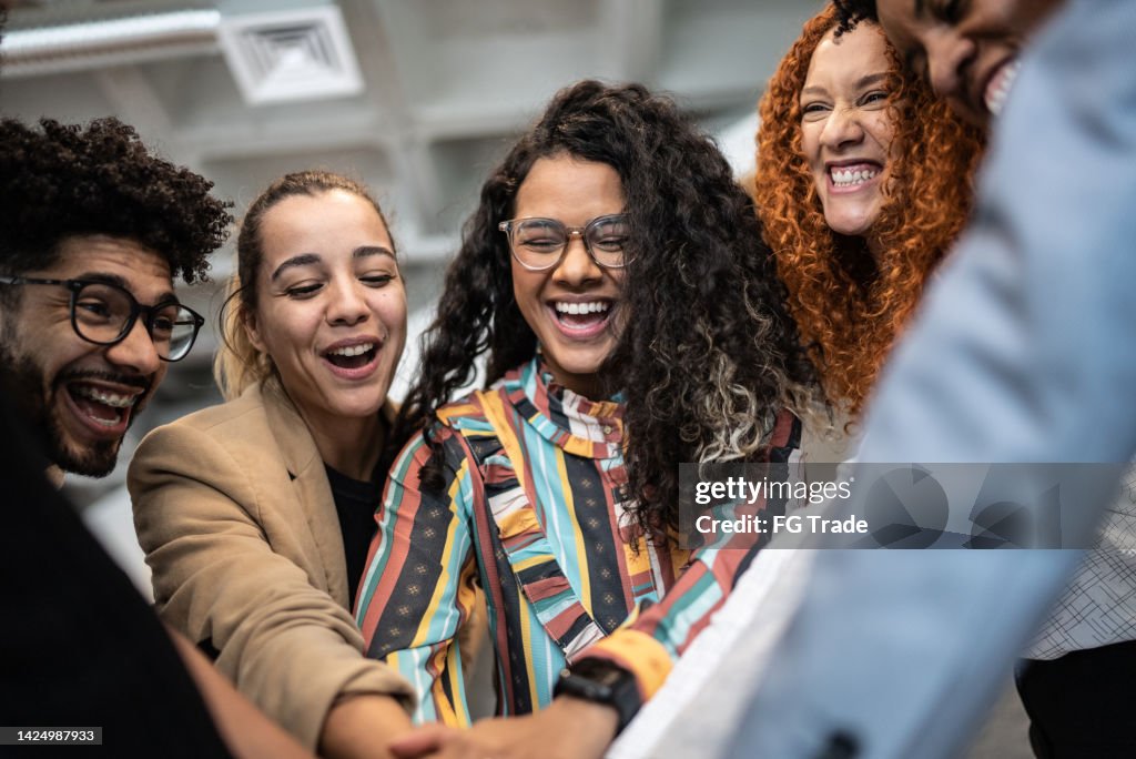 Coworkers with stacked hands at the office