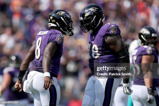 Lamar Jackson and Morgan Moses of the Baltimore Ravens celebrate after scoring a touchdown in the second quarter against the New England Patriots at...