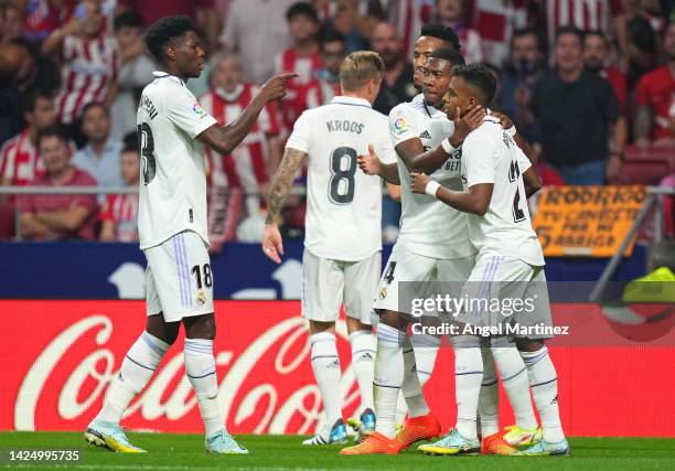 Rodrygo of Real Madrid celebrates with teammates after scoring their team's first goal during the LaLiga Santander match between Atletico de Madrid...