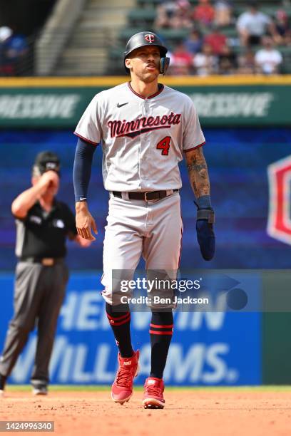 Carlos Correa of the Minnesota Twins walks back to first base following a foul ball during the sixth inning of a game against the Cleveland Guardians...