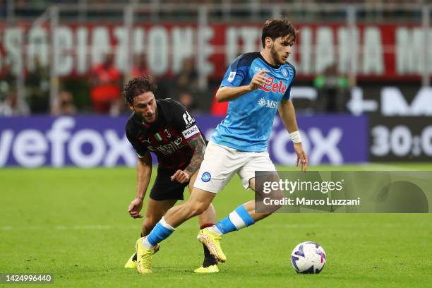 Khvicha Kvaratskhelia of SSC Napoli is challenged by Davide Calabria of AC Milan during the Serie A match between AC Milan and SSC Napoli at Stadio...