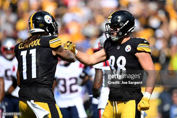 Pat Freiermuth of the Pittsburgh Steelers celebrates after a touchdown with Chase Claypool during the second half in the game against the New England...