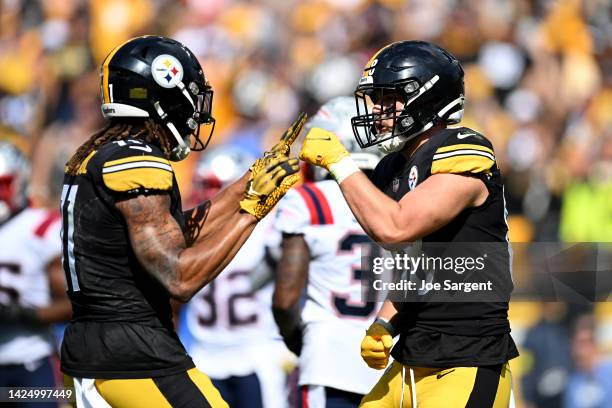 Pat Freiermuth of the Pittsburgh Steelers celebrates after a touchdown with Chase Claypool during the second half in the game against the New England...