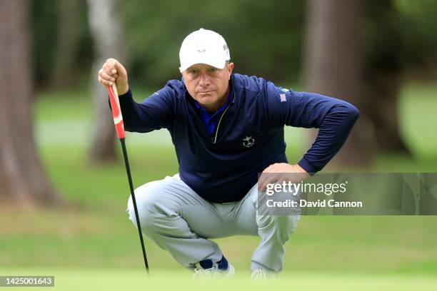 Greig Hutcheon of the Great Britain and Ireland team lines up a putt during the singles matches on Day Three of the 2022 PGA Cup on The Longcross...