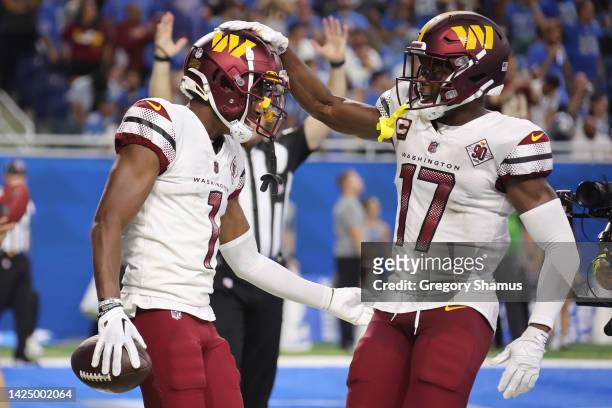 Jahan Dotson of the Washington Commanders is congratulated by Terry McLaurin after making a catch for a two-point conversion against the Detroit...