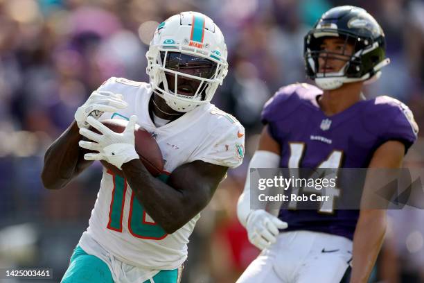 Tyreek Hill of the Miami Dolphins catches a pass for a touchdown in the fourth quarter against Kyle Hamilton of the Baltimore Ravens at M&T Bank...