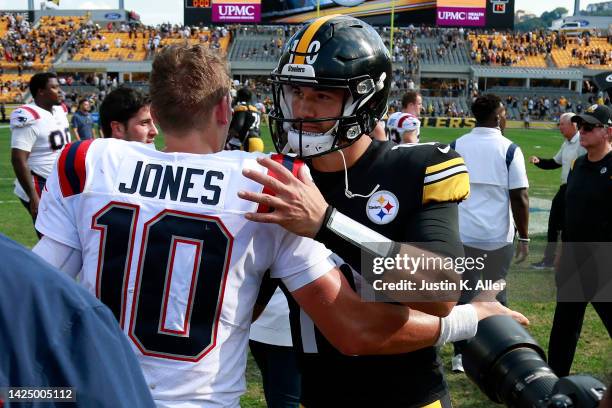 Mac Jones of the New England Patriots embraces Mitch Trubisky of the Pittsburgh Steelers after the game at Acrisure Stadium on September 18, 2022 in...