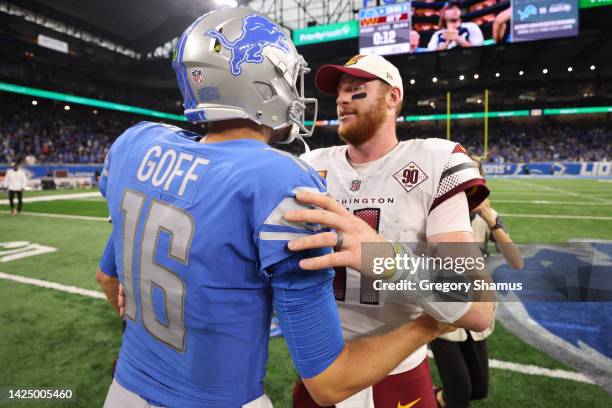 Jared Goff of the Detroit Lions and Carson Wentz of the Washington Commanders embrace after the game at Ford Field on September 18, 2022 in Detroit,...