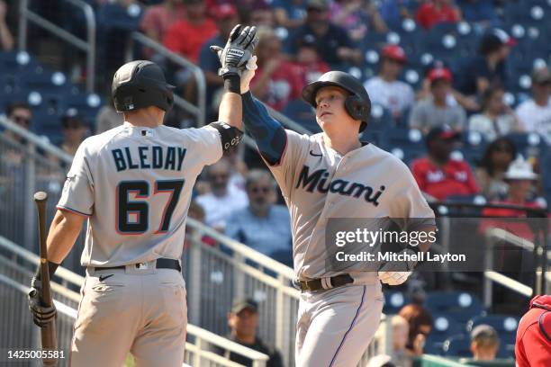 Garrett Cooper of the Miami Marlins celebrates a solo home run in the sixth inning with JJ Bleday against the Washington Nationals at Nationals Parks...