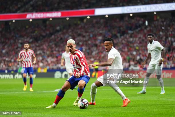 Antoine Griezmann of Atletico de Madrid is put under pressure by Eder Militao of Real Madrid during the LaLiga Santander match between Atletico de...
