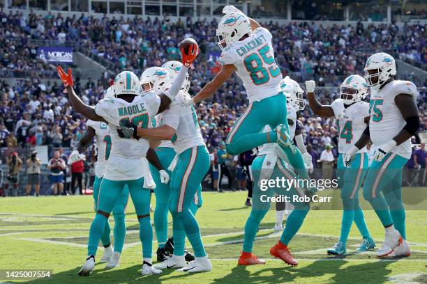 Jaylen Waddle of the Miami Dolphins celebrates with teammates after a touchdown in the fourth quarter against the Baltimore Ravens at M&T Bank...