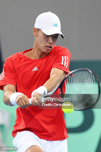 Min-Hyeok Cho of Korea plays a backhand in his singles match against Bernard Tomic of Australia on day one of the Davis Cup Asia Oceania Zone Second...