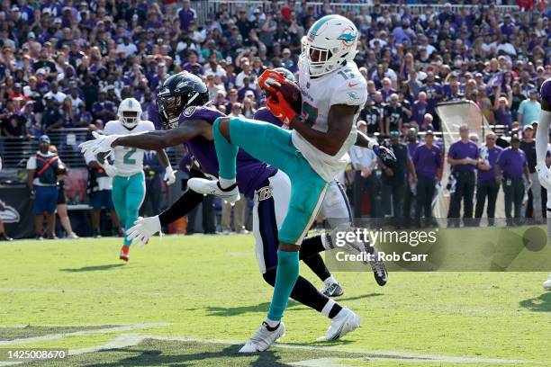 Jaylen Waddle of the Miami Dolphins catches a pass for a touchdown in the fourth quarter against the Baltimore Ravens at M&T Bank Stadium on...