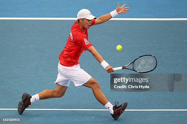 Min-Hyeok Cho of Korea plays a backhand in his singles match against Bernard Tomic of Australia on day one of the Davis Cup Asia Oceania Zone Second...