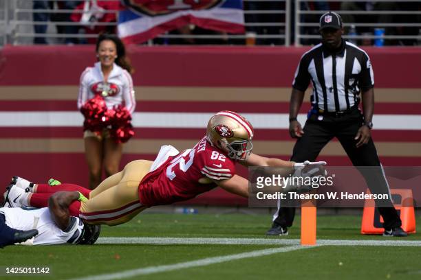 Ross Dwelley of the San Francisco 49ers dives for a touchdown against Quandre Diggs of the Seattle Seahawks during the second quarter at Levi's...