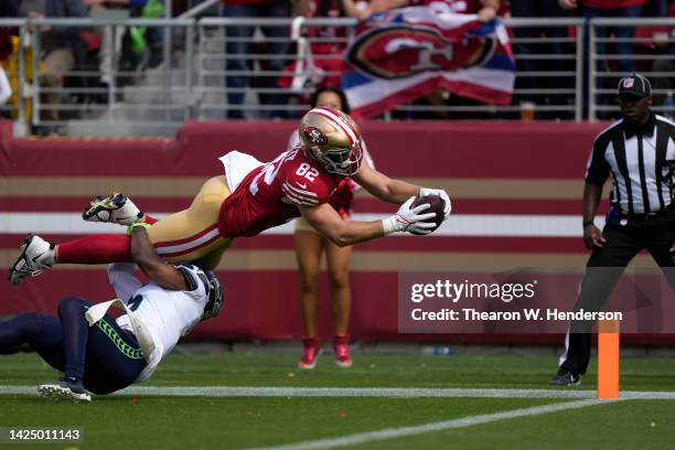 Ross Dwelley of the San Francisco 49ers dives for a touchdown against Quandre Diggs of the Seattle Seahawks during the second quarter at Levi's...