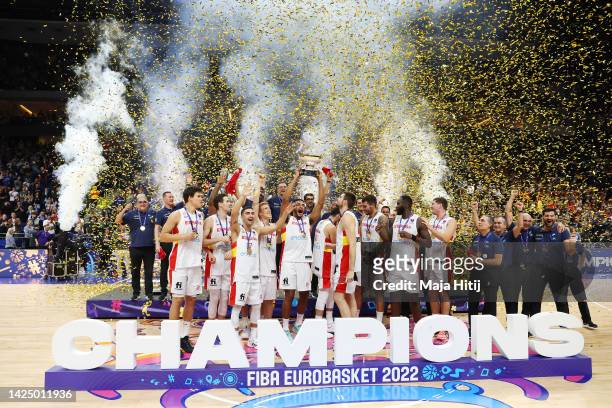 Sebastian Saiz of Spain celebrates with teammates while lifting the Nikolai Semashko Trophy on the podium following their victory in the FIBA...
