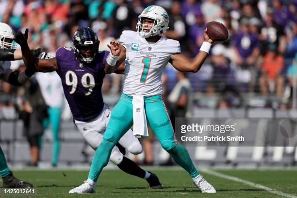 Tua Tagovailoa of the Miami Dolphins throws a pass against Odafe Oweh of the Baltimore Ravens in the second half at M&T Bank Stadium on September 18,...