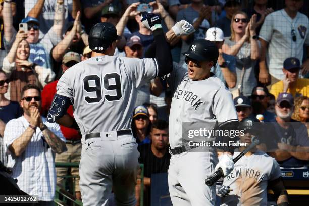 Anthony Rizzo of the New York Yankees congratulates Aaron Judge after Judge's second home run of the game in the seventh inning against the Milwaukee...