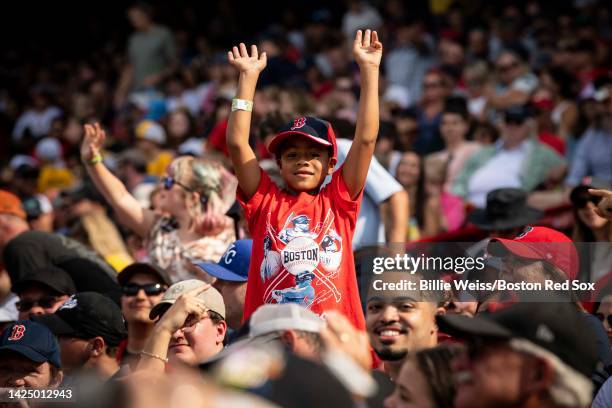 Young fan cheers during a game between the Boston Red Sox and the Kansas City Royals on September 18, 2022 at Fenway Park in Boston, Massachusetts.