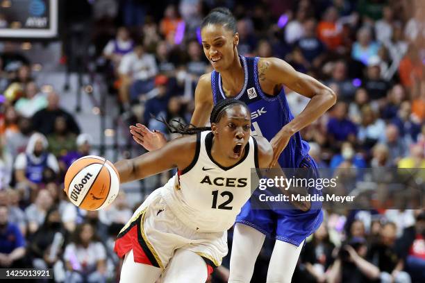 Chelsea Gray of the Las Vegas Aces dribbles against DeWanna Bonner of the Connecticut Sun in the first half during game four of the 2022 WNBA Finals...