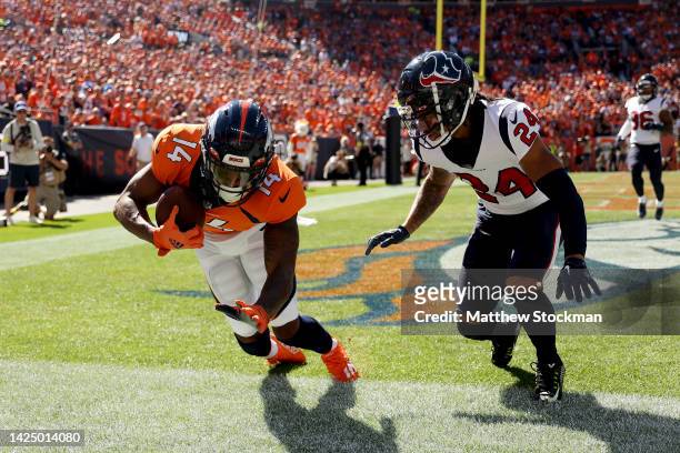 Courtland Sutton of the Denver Broncos attempts to catch a pass that was ruled incomplete during the first half of the game against the Houston...