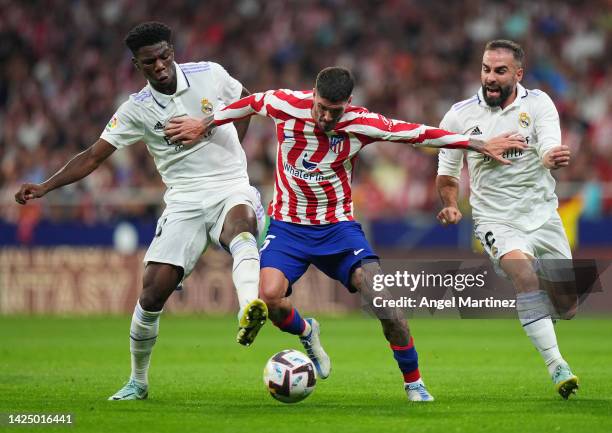 Rodrigo De Paul of Atletico de Madrid battles for possession with Aurelien Tchouameni and Dani Carvajal of Real Madrid during the LaLiga Santander...