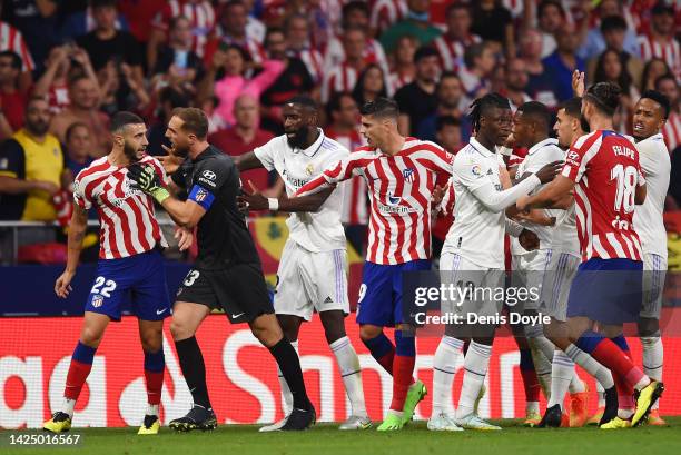 Players clash during the LaLiga Santander match between Atletico de Madrid and Real Madrid CF at Civitas Metropolitano Stadium on September 18, 2022...