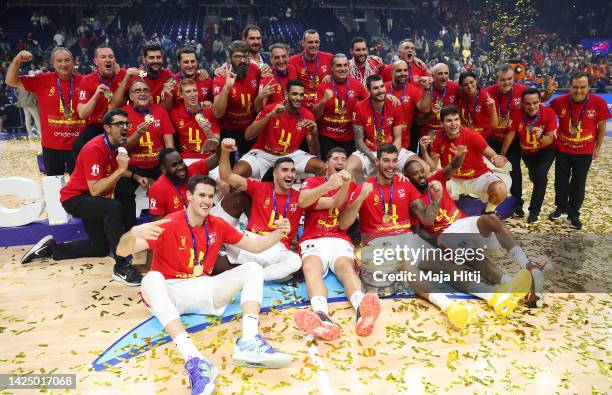 Players and coaching staff of Spain celebrate with their gold medals and The Nikolai Semashko Trophy following their side's victory in the FIBA...